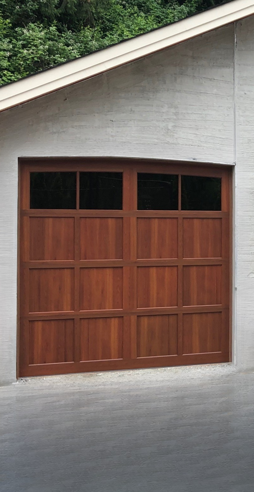 Close-up of a stained wood carriage garage door with windows