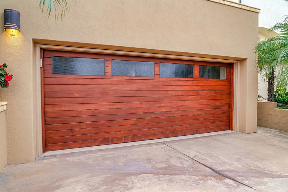 Dark gray contemporary garage door on a shingled garage