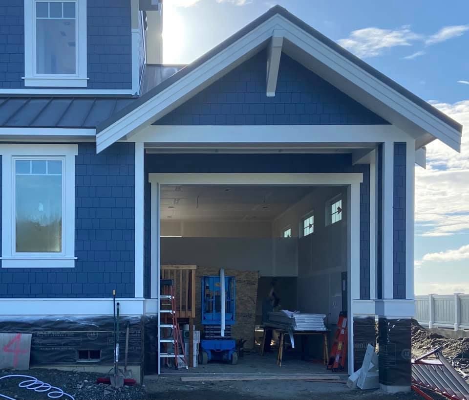 Blue home without a garage door before installation