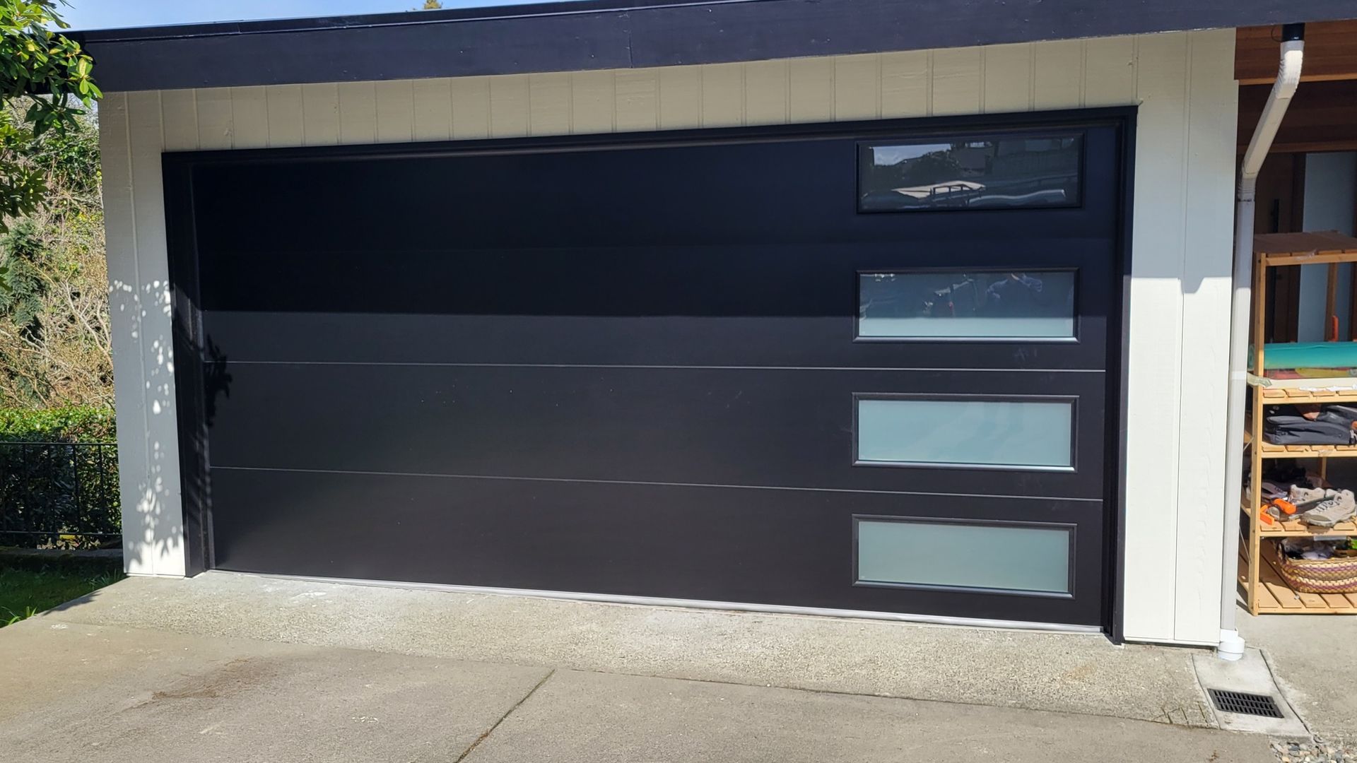 Close-up of a black contemporary garage door with window accents