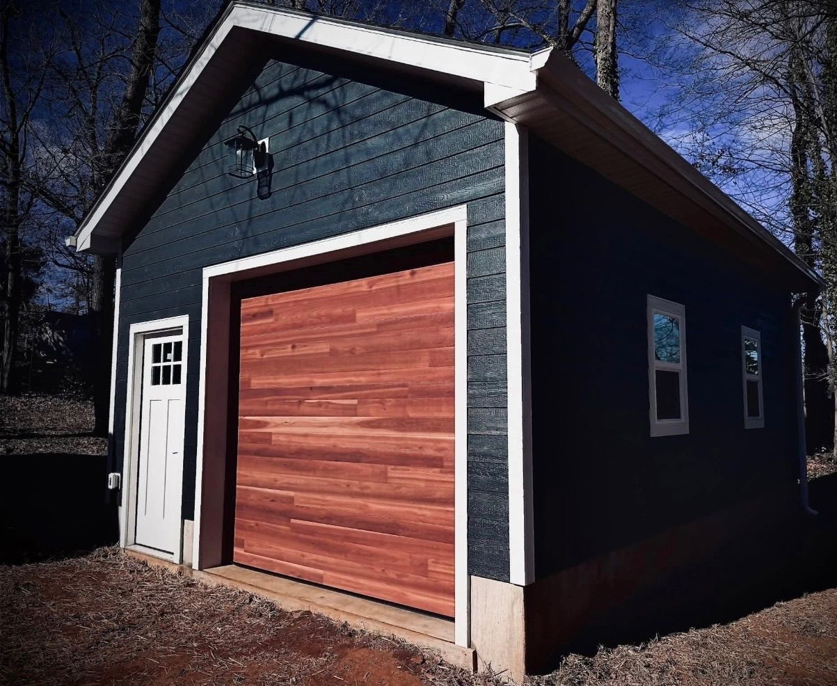 Close-up of a wood-tone garage door on a dark home