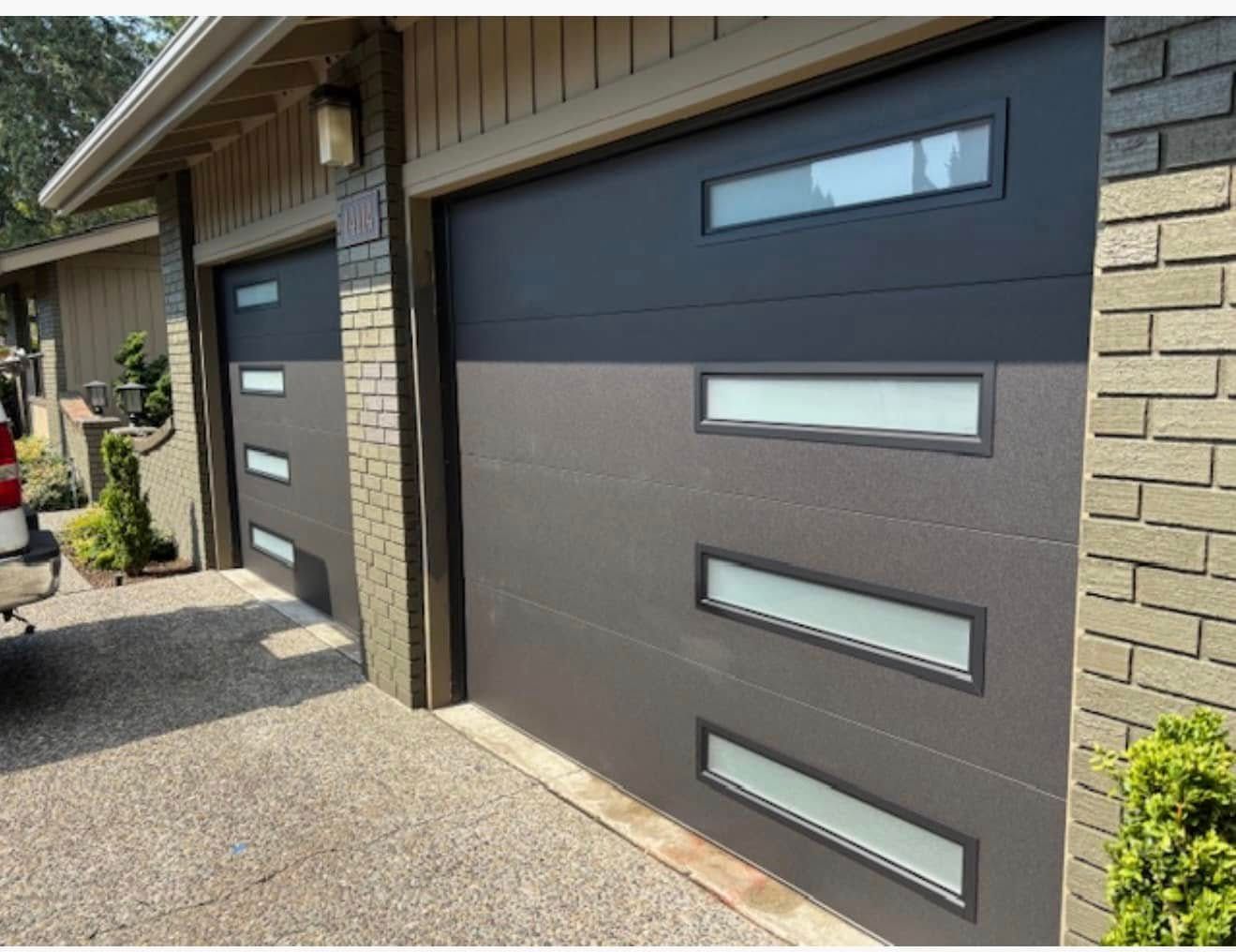 Dark gray contemporary garage door with window accents