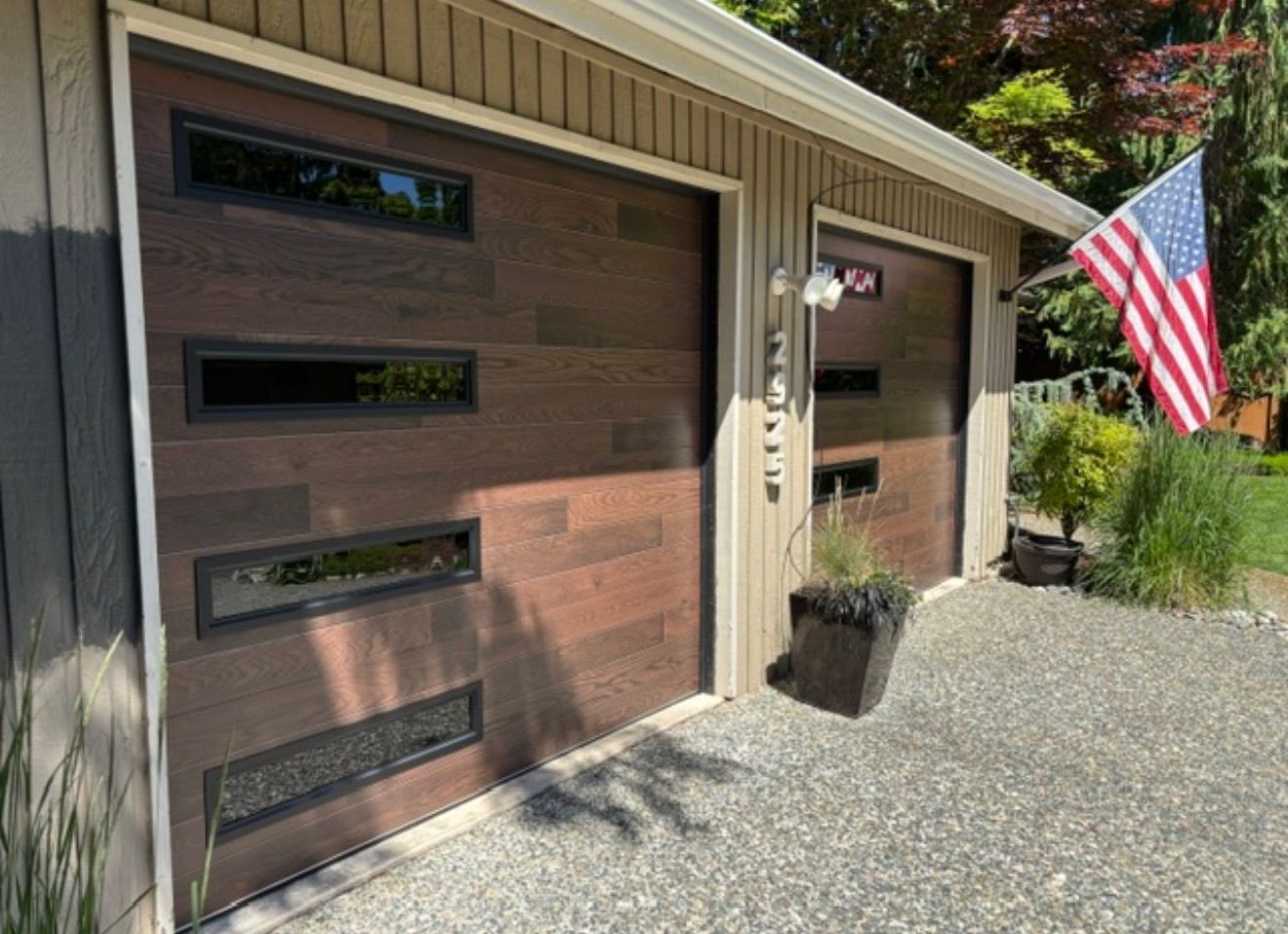 Close-up of a wood-tone contemporary garage door with narrow windows