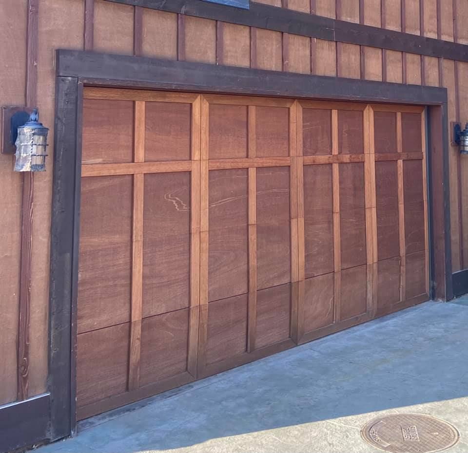 Home with an old wood garage door before replacement