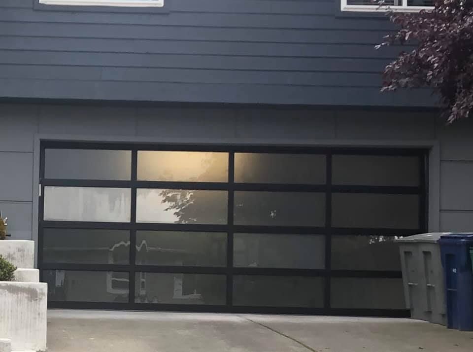 Close-up of a black-frame frosted glass garage door
