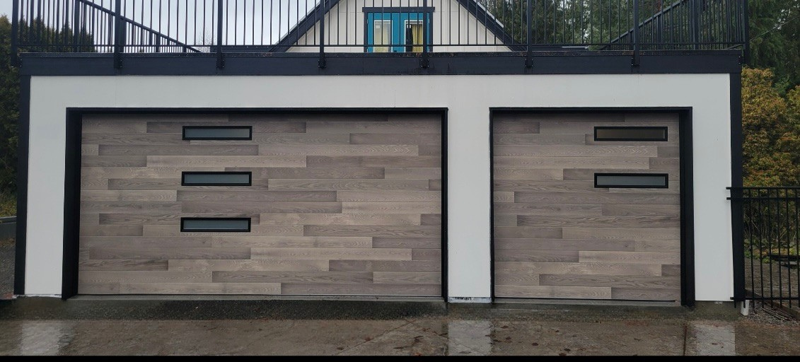 Wood-tone contemporary garage door with window accents