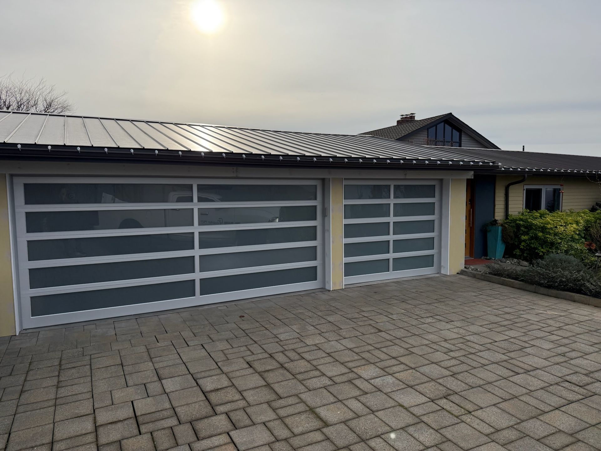 Three-car garage with full-view glass contemporary garage doors