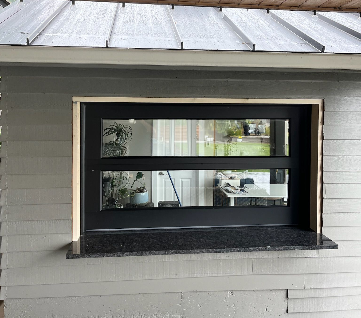Small pass-through window with a frosted glass panel for a patio