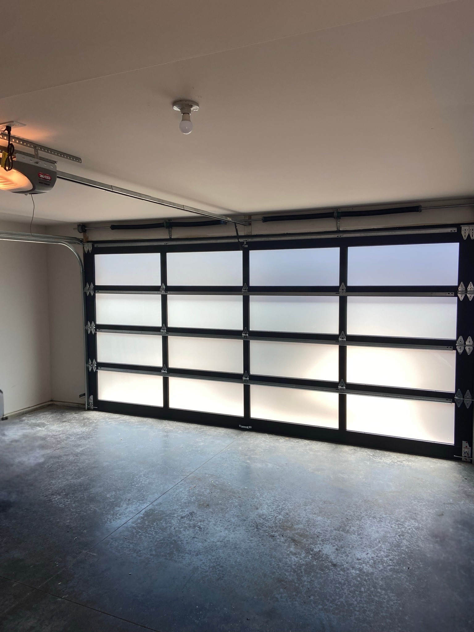 Close-up of a black-frame frosted glass garage door