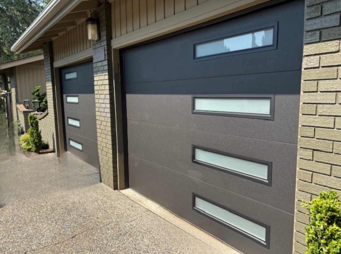 Home with a new dark panel contemporary garage door