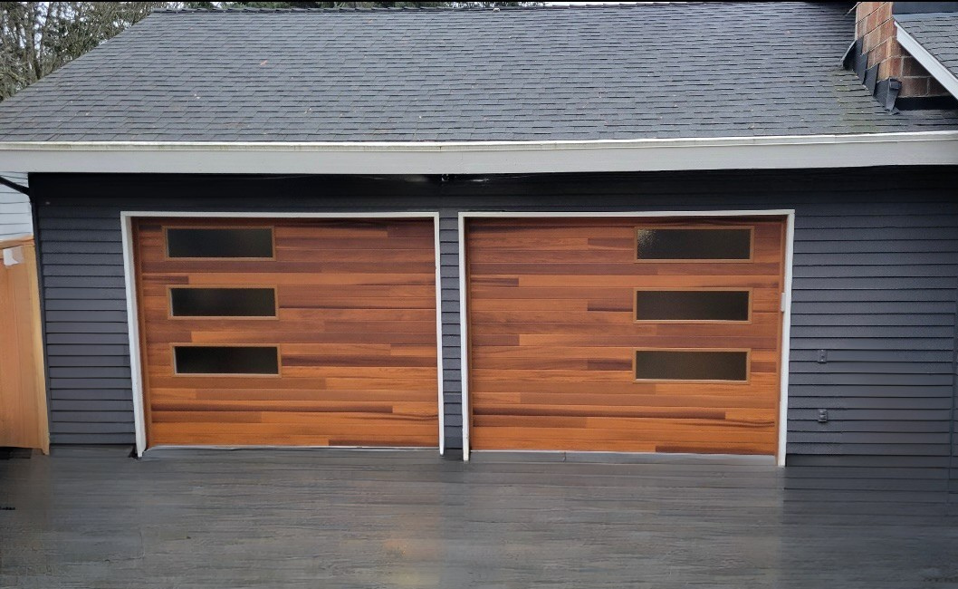Wood-tone contemporary garage doors on a two-car garage
