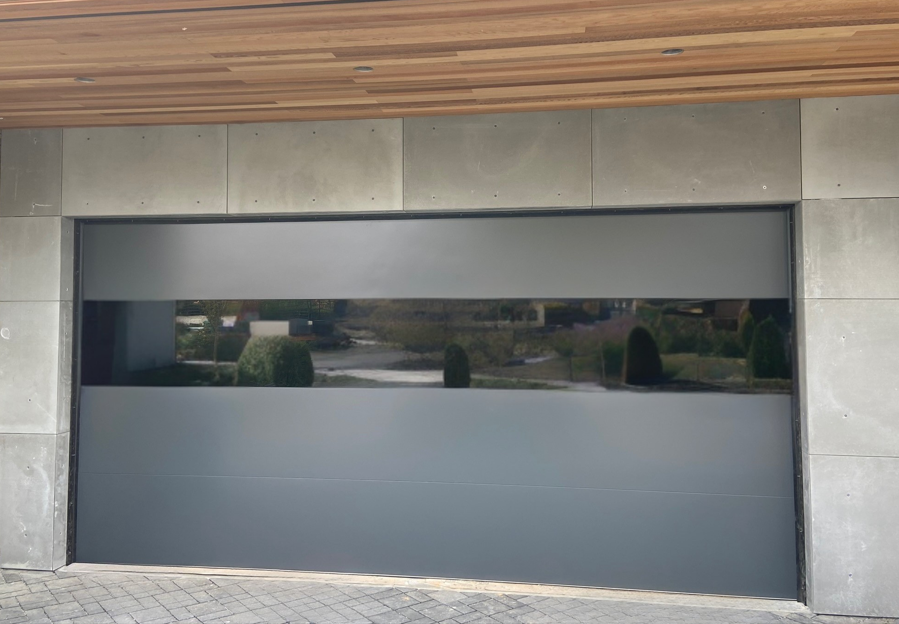 Close-up of a frosted glass garage door with stone surround