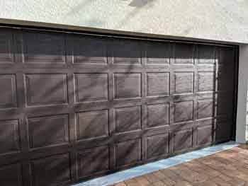 Close-up of a dark walnut traditional steel garage door