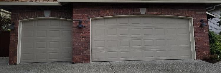 Brick home with an old tan panel garage door before replacement