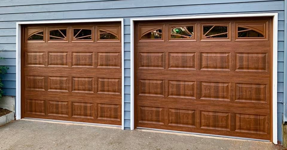 Mahogany-stained traditional steel garage doors with sunburst window panes
