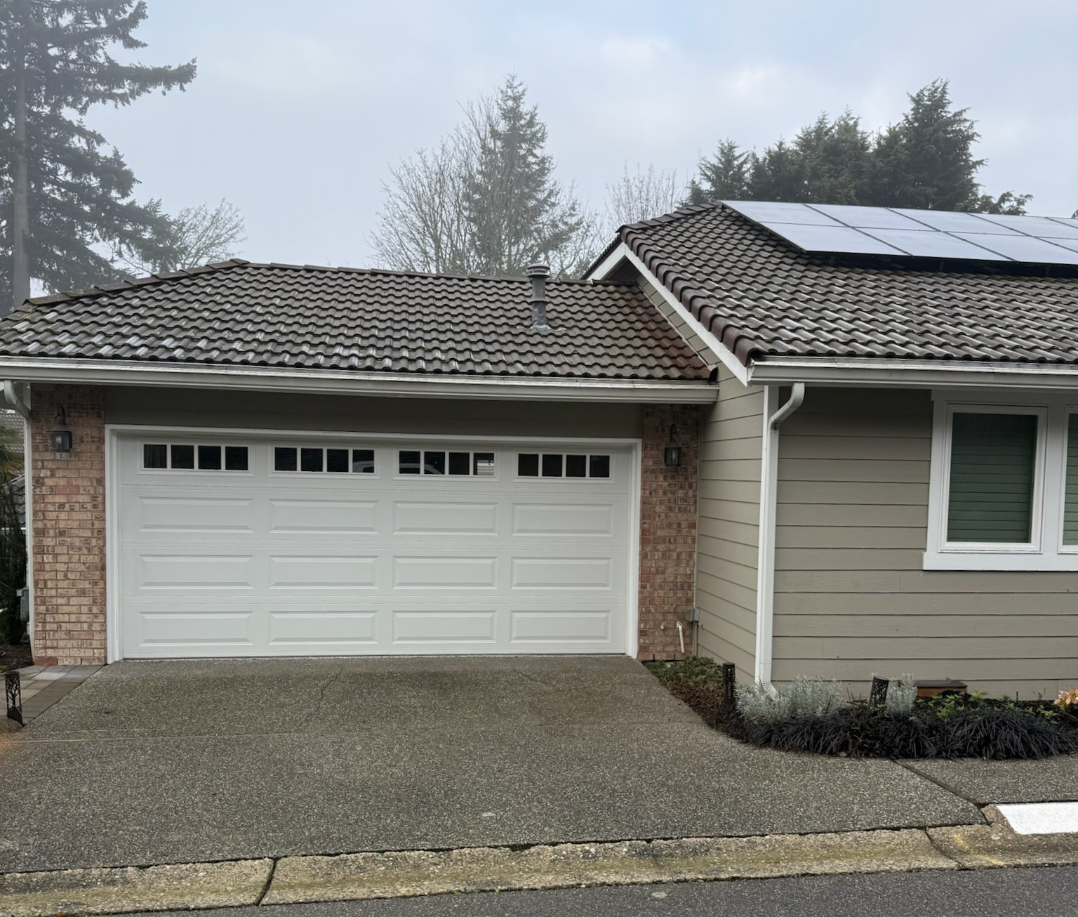 White traditional steel garage door with narrow rectangular windows