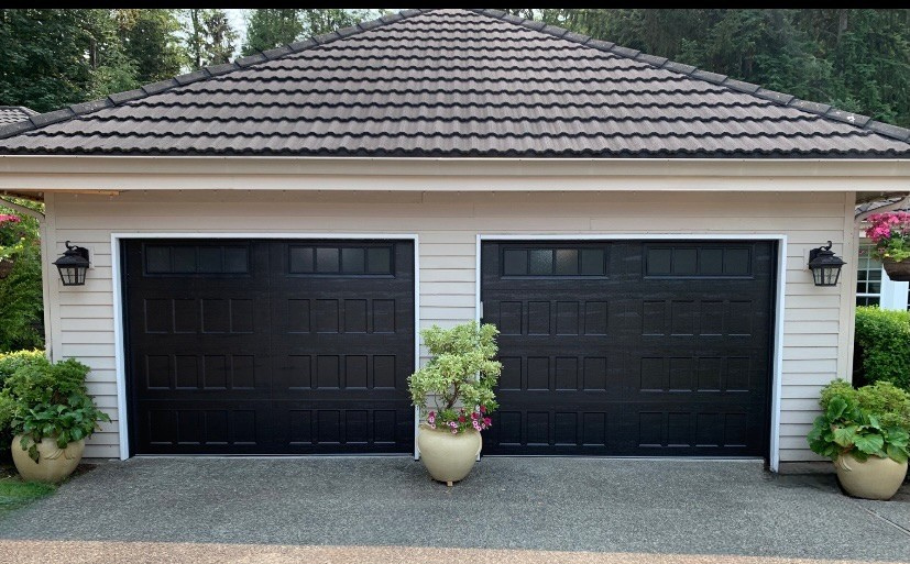 Traditional wood carriage house garage doors with decorative handles