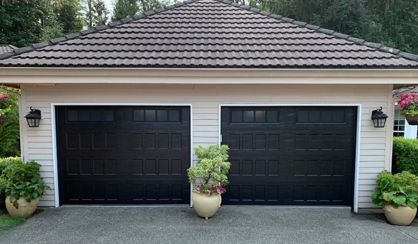 Detached garage with black steel carriage house garage doors