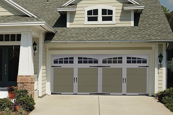 Craftsman-style home with an olive steel carriage house garage door, square windows, and black hardware