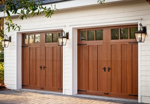 Wood carriage-style garage doors with decorative hardware