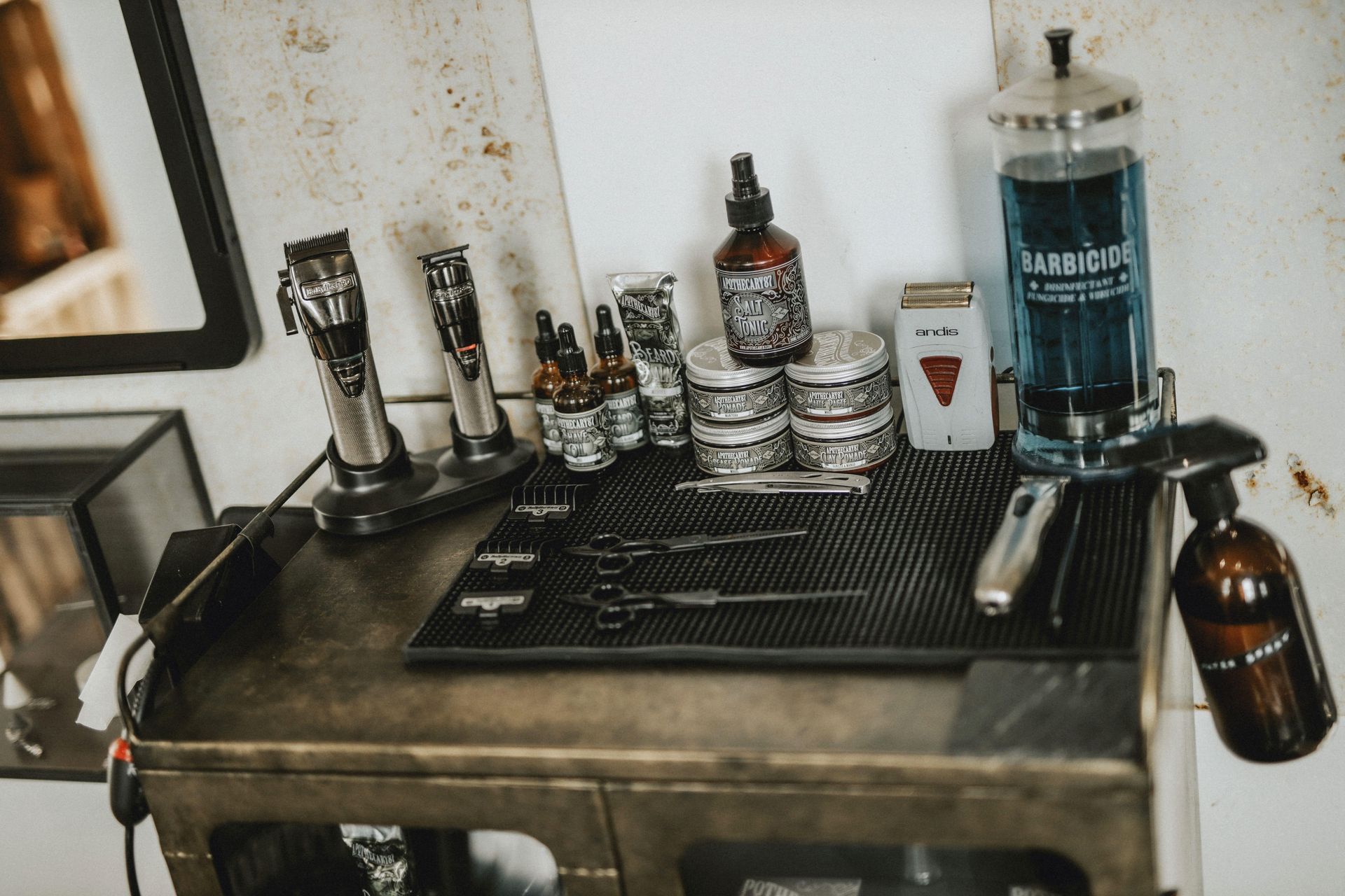 Barber station with clippers, shears, and grooming products.