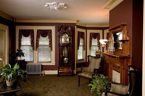 A living room with a large grandfather clock and a fireplace