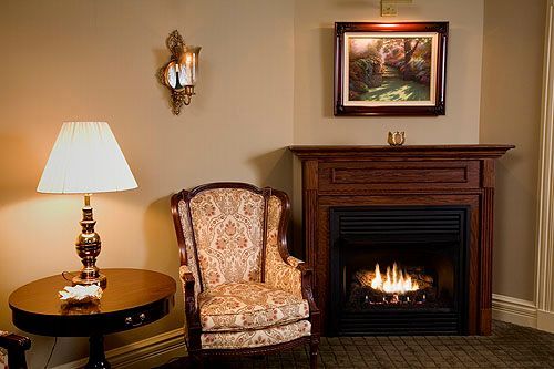 A living room with a fireplace and a chair