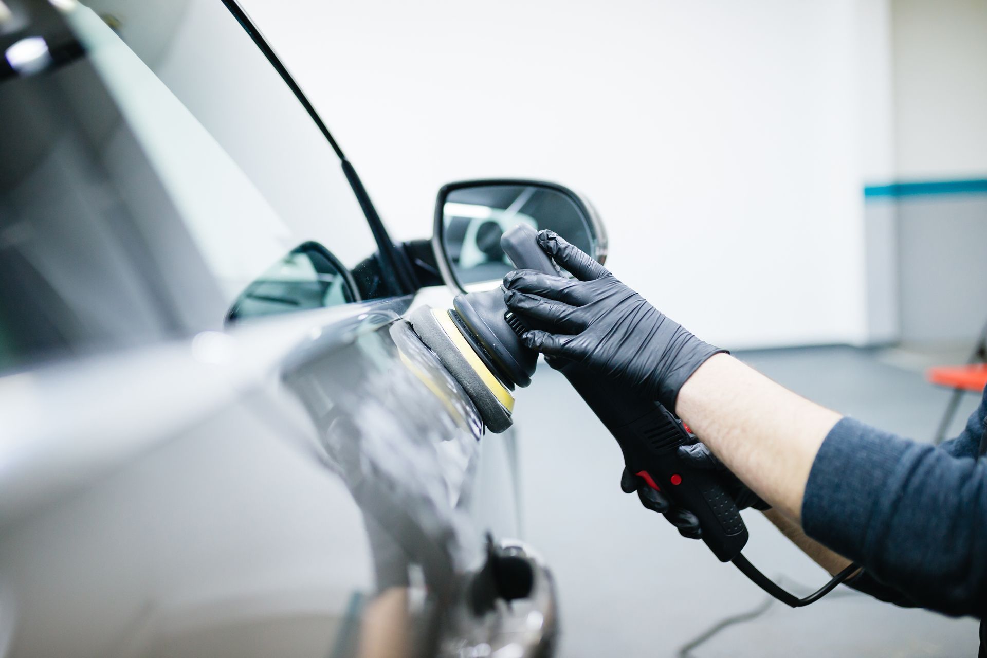 a person is polishing a car with a machine
