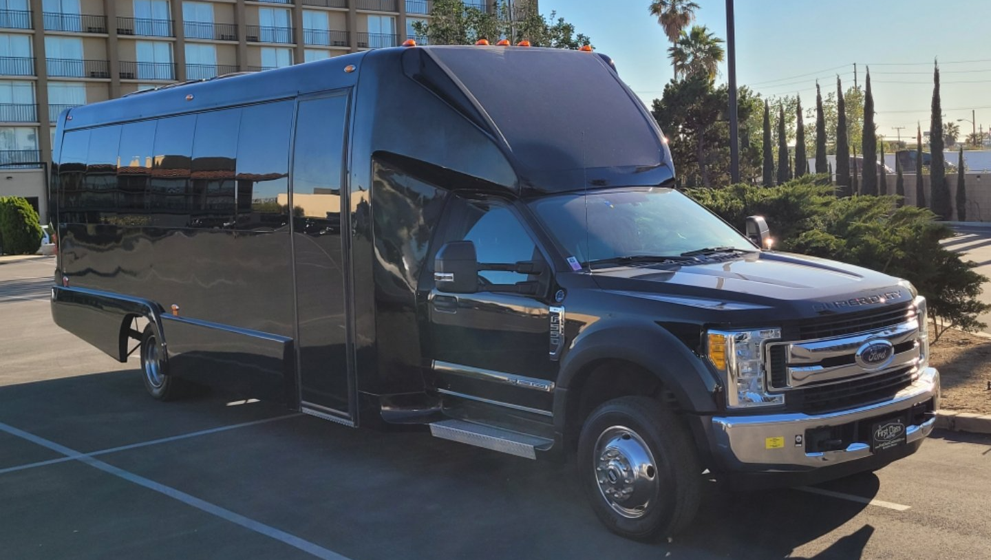 A large black truck is parked in a parking lot.