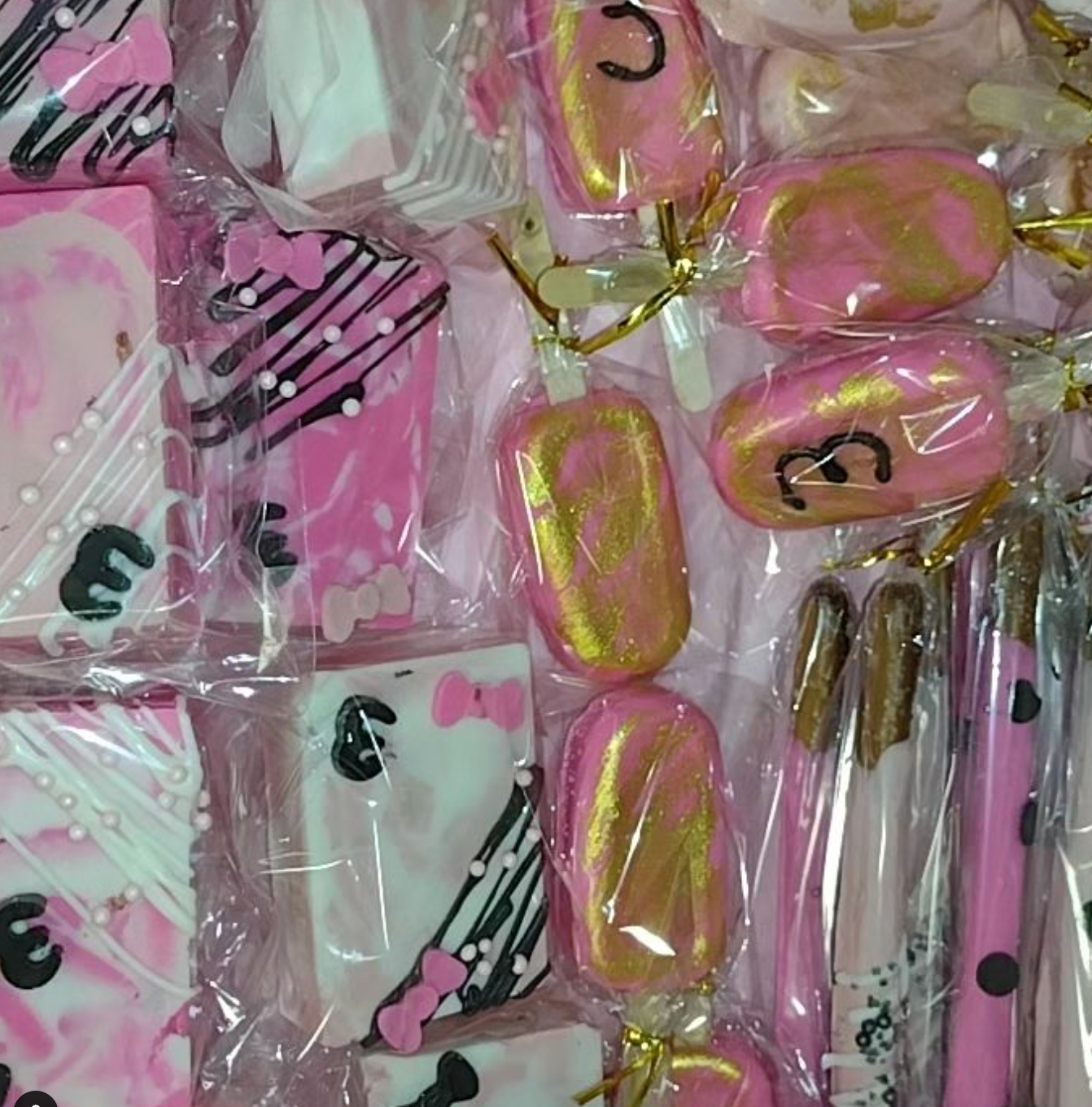 A bunch of pink candy with the number 3 on them