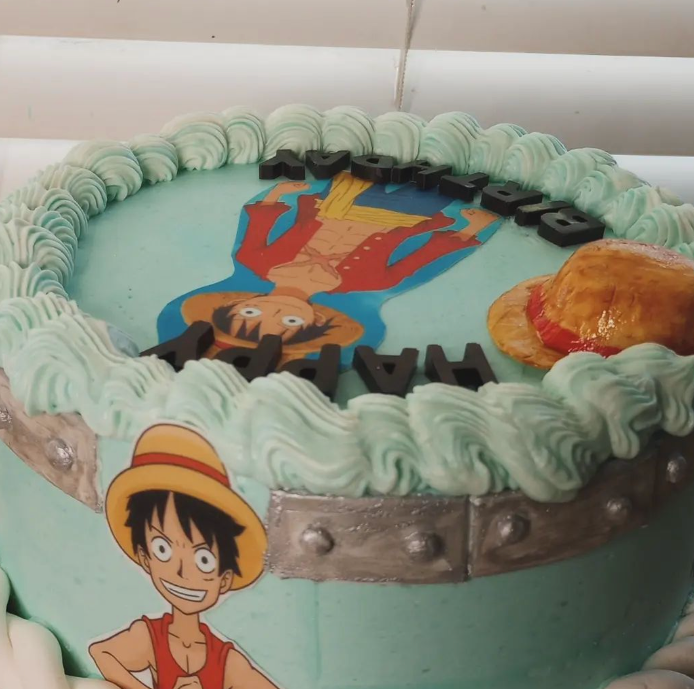 A cake with a picture of luffy on it
