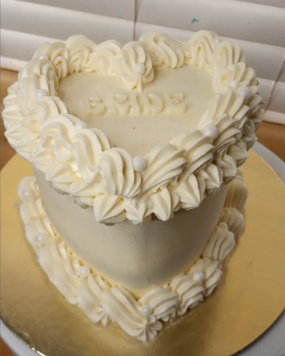 A heart shaped cake with the word bride on it