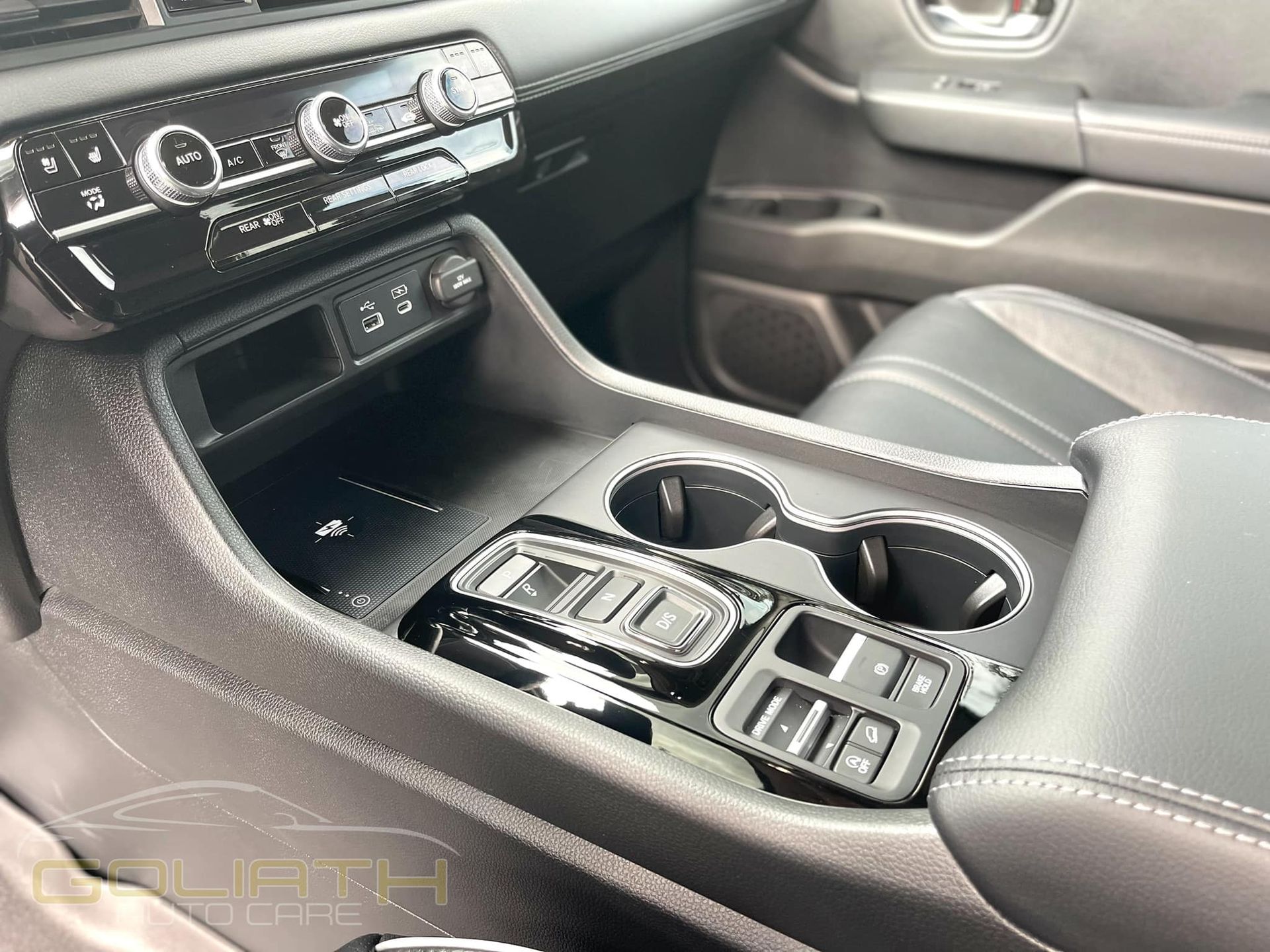 a close up of the center console of a car with cup holders .