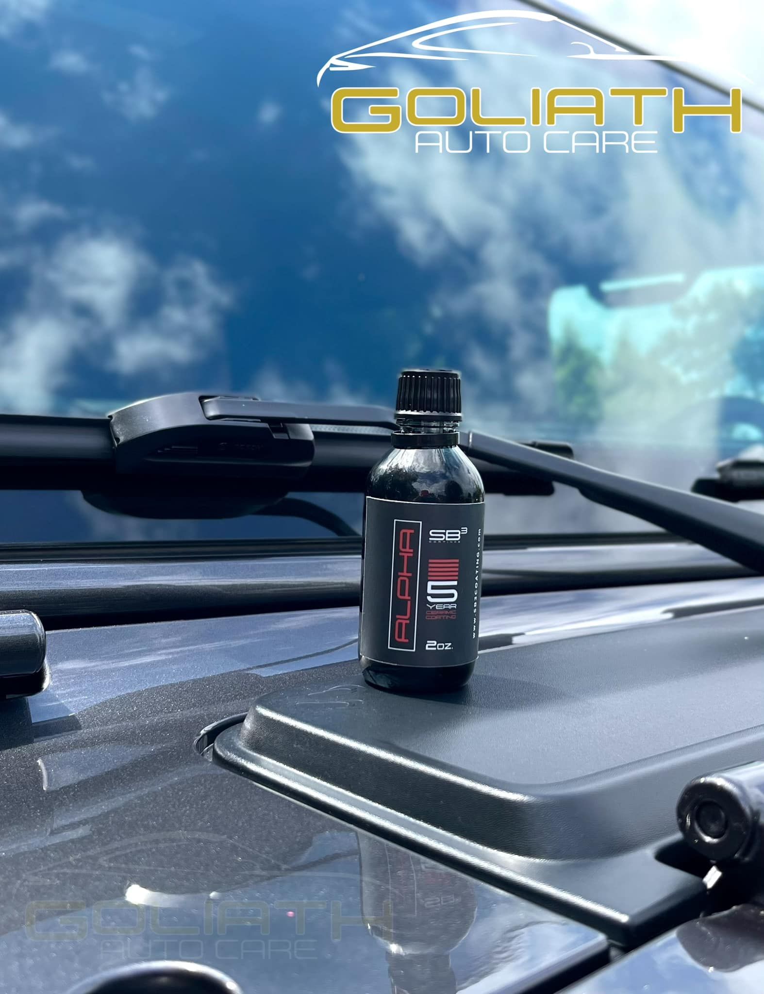 a bottle of oil sits on the hood of a car