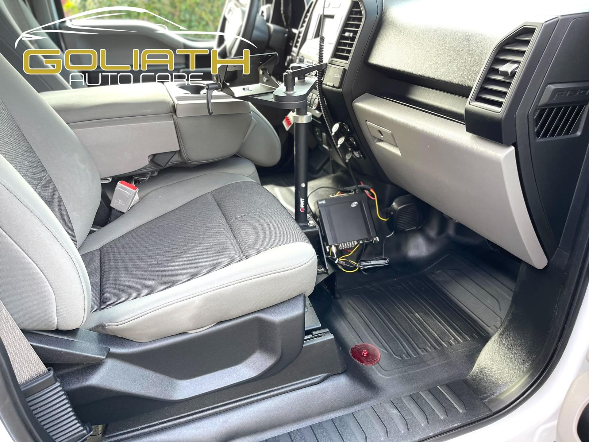 the interior of a white truck with the word goliath on the dashboard