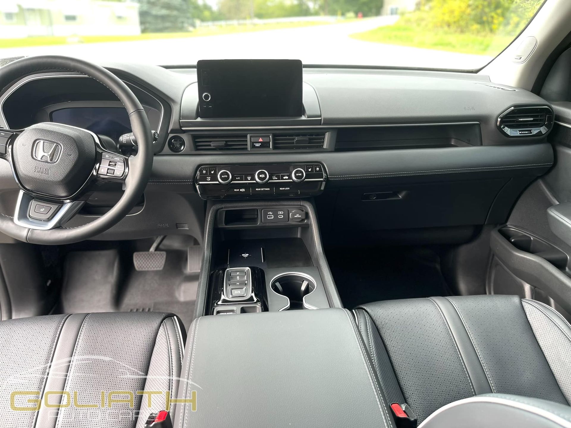 the interior of a car with a steering wheel and dashboard .