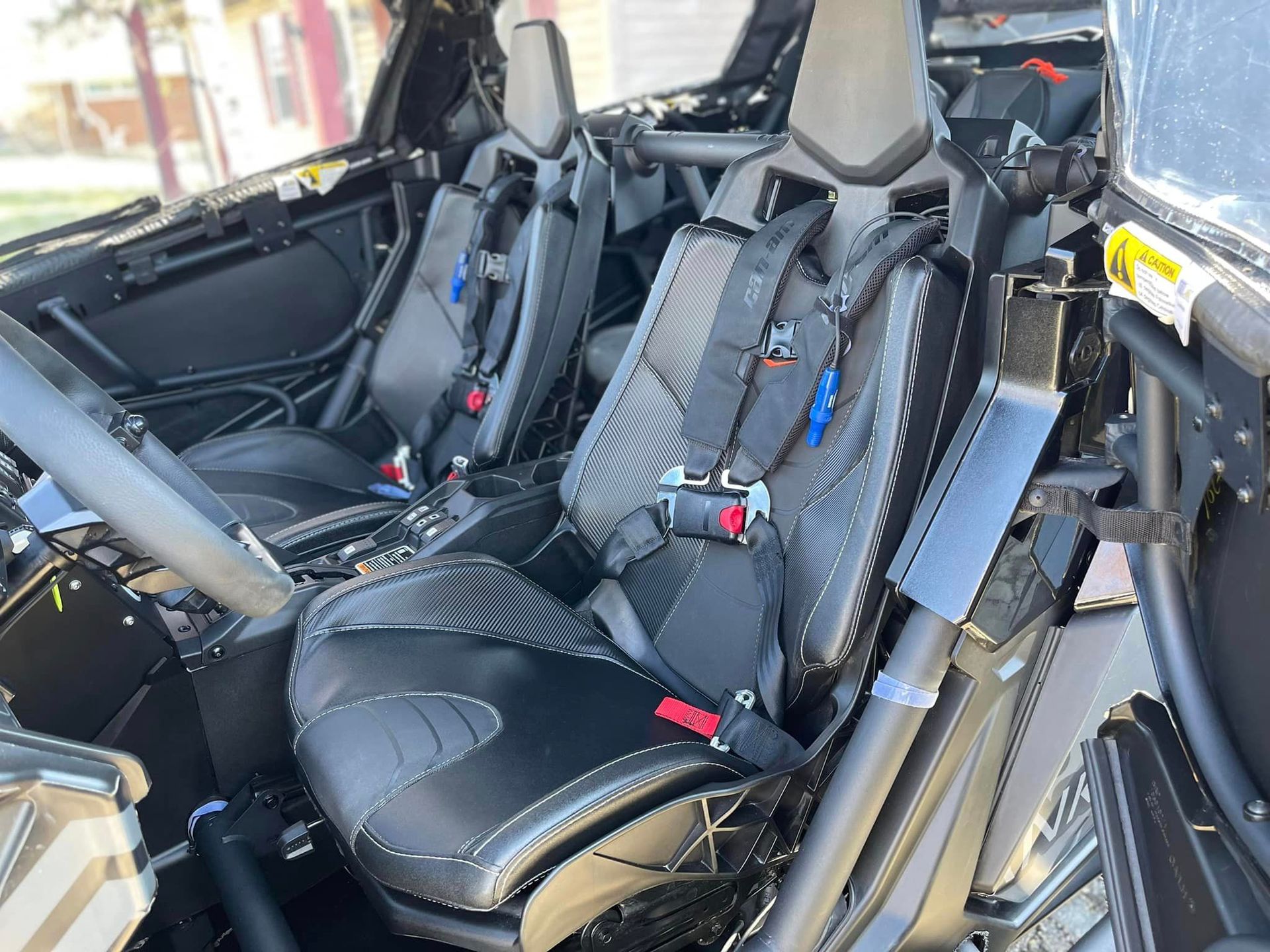the inside of a can am maverick x3 with seat belts .