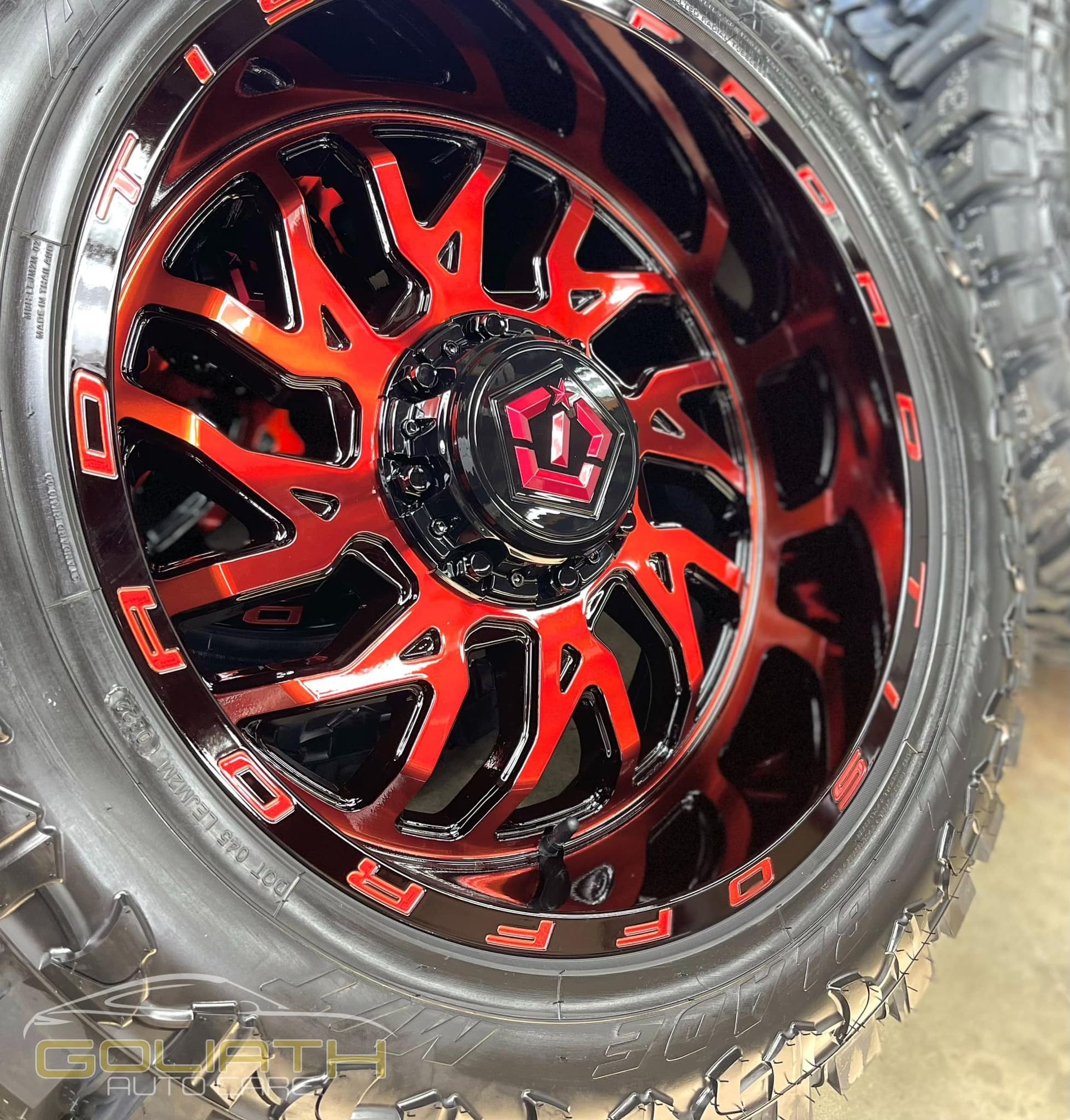 a close up of a red and black wheel on a tire