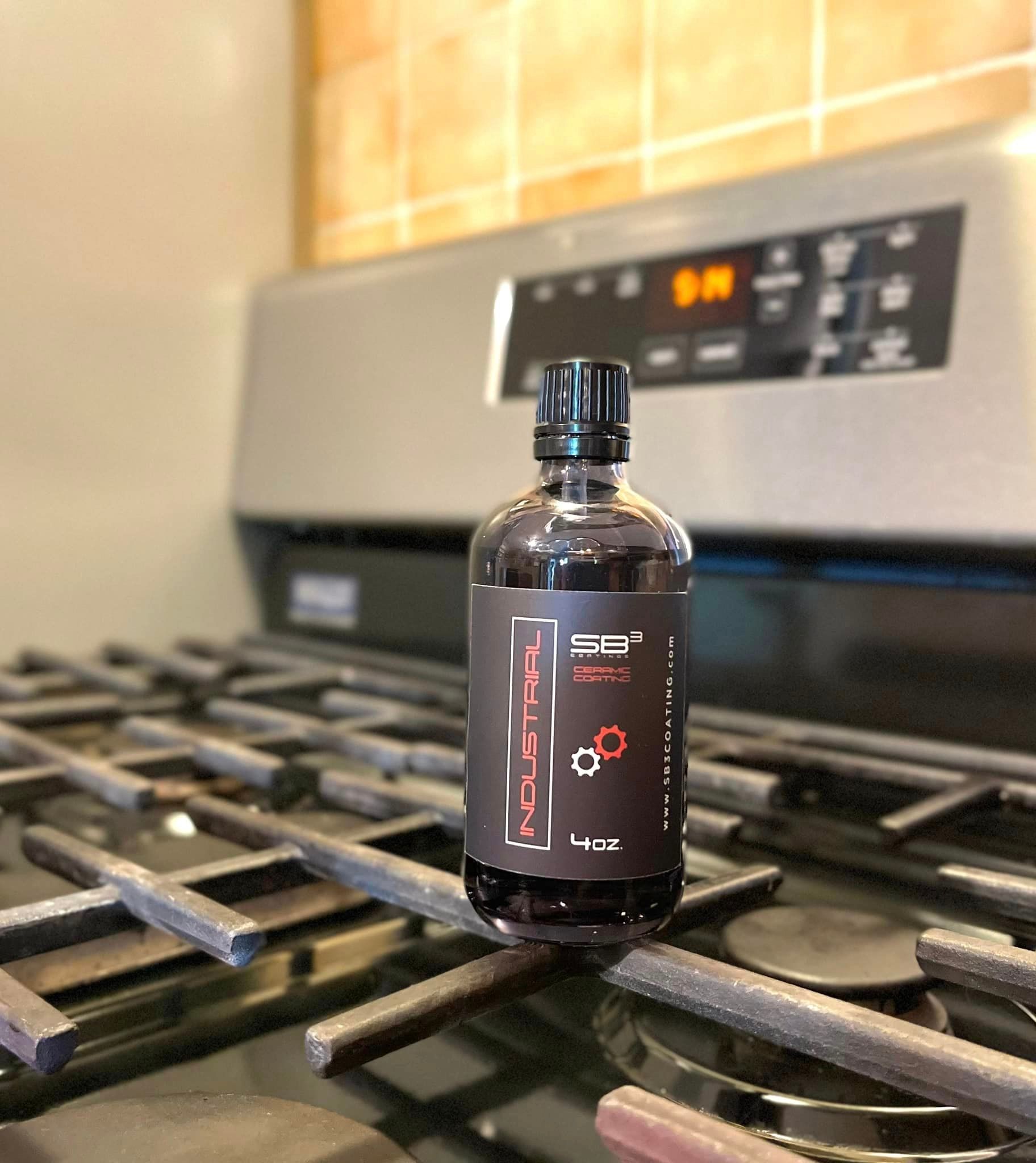a bottle of liquid is sitting on top of a stove .