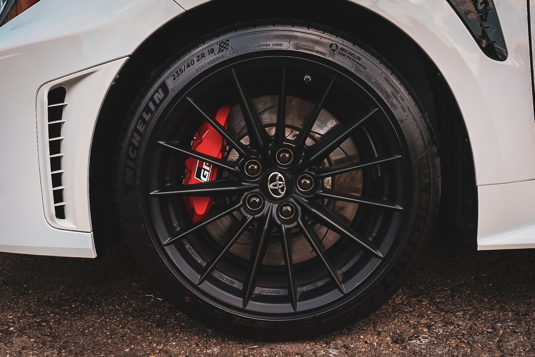 a man is polishing a black truck in a garage .