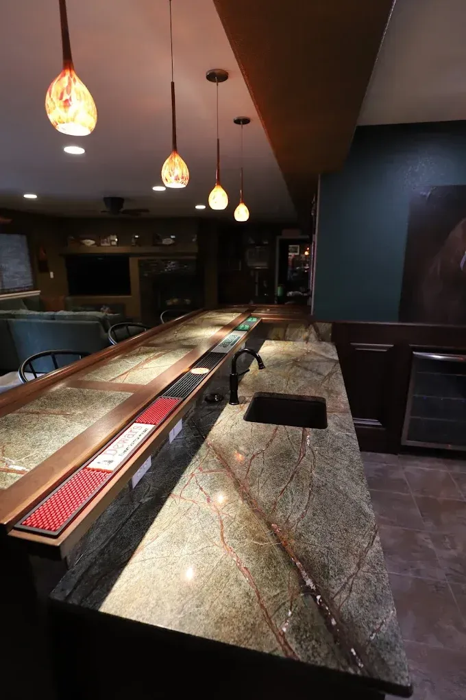 Empty bar interior with marble counter and hanging pendant lights