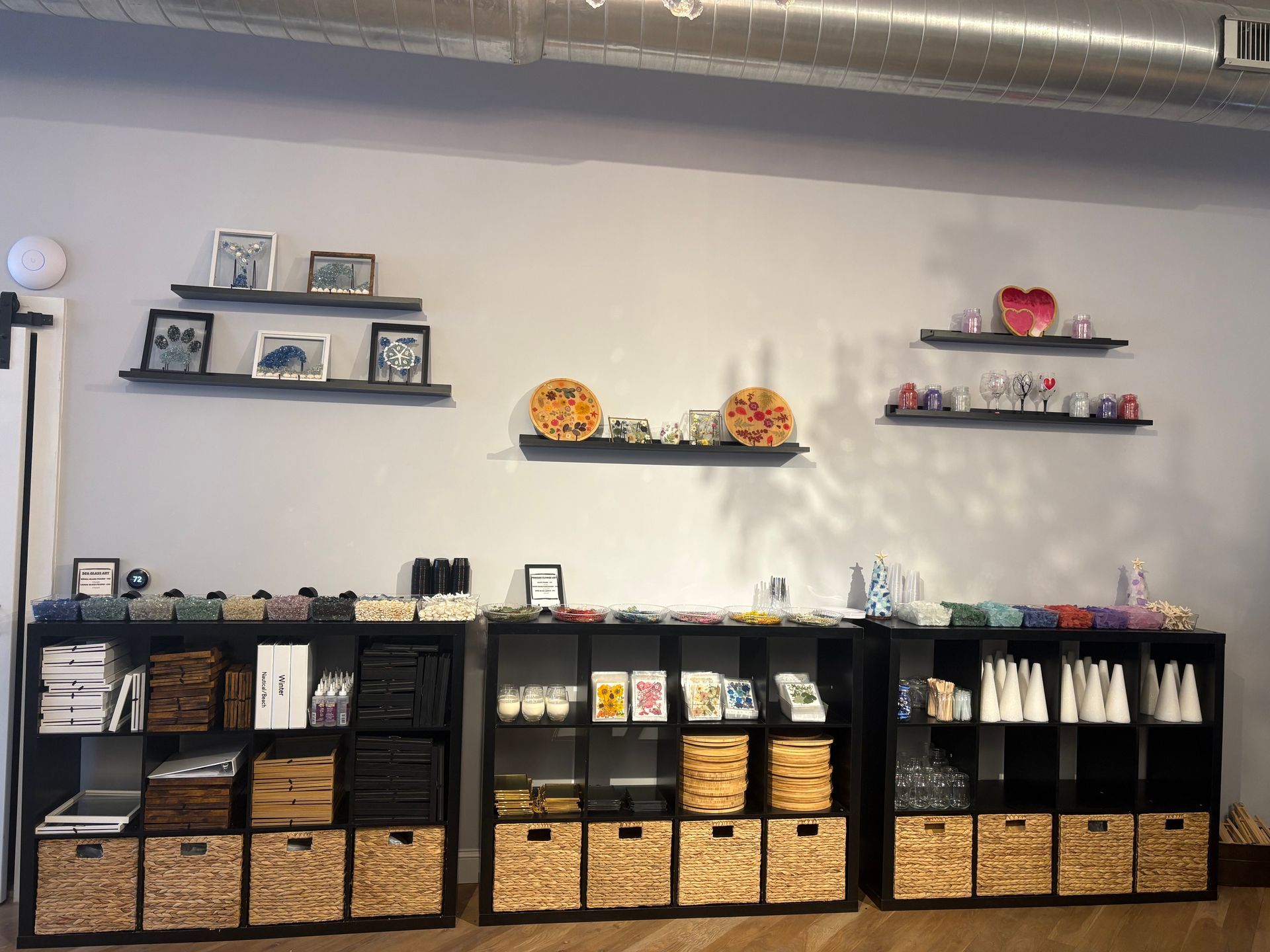 Shelves and woven baskets display small decor items and gifts in a tidy shop interior.