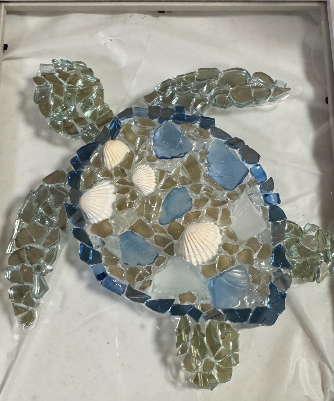 Mosaic sea turtle with blue and clear glass pieces on a white background