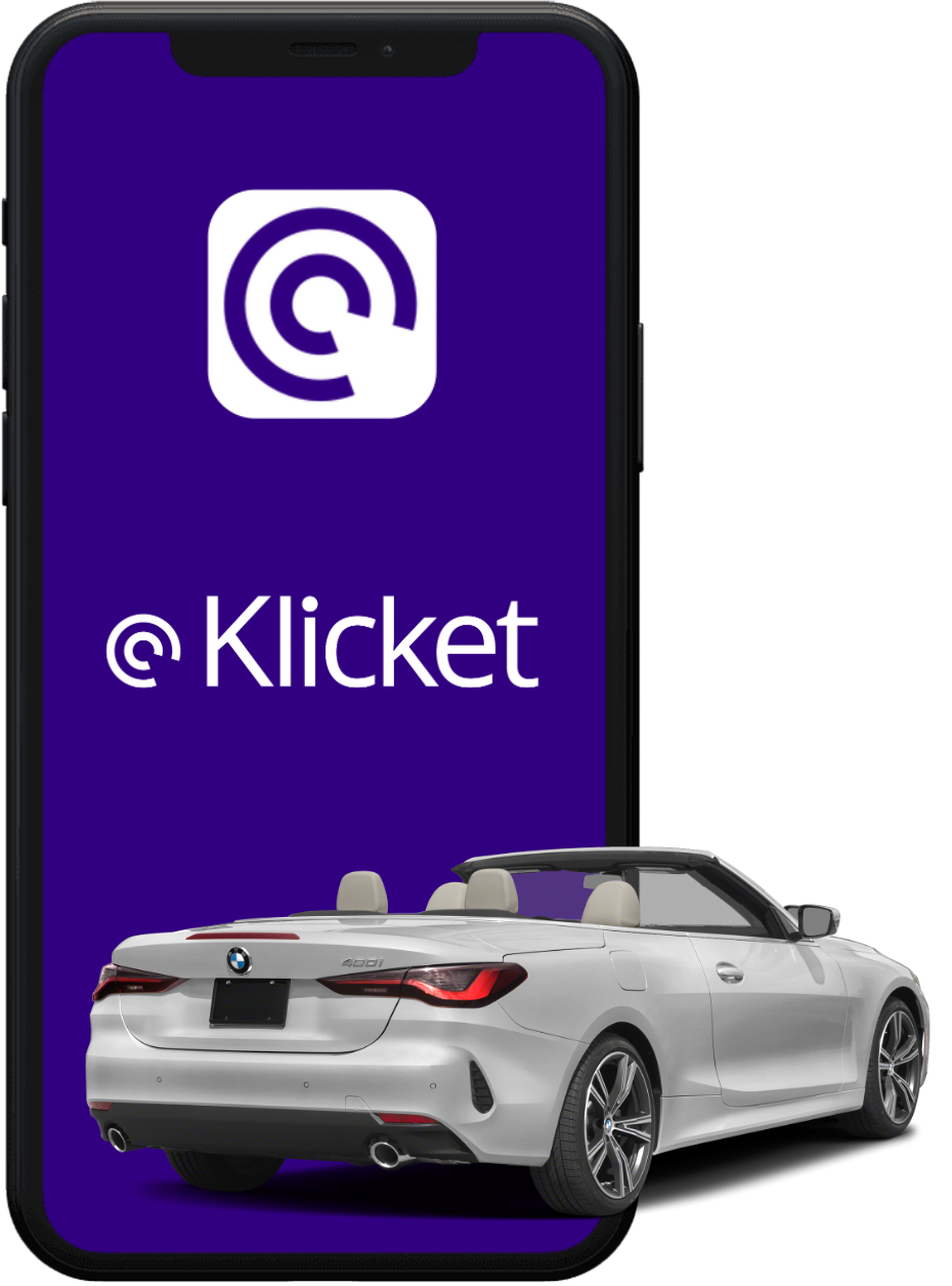 Smartphone with Klicket app logo next to a silver convertible car.