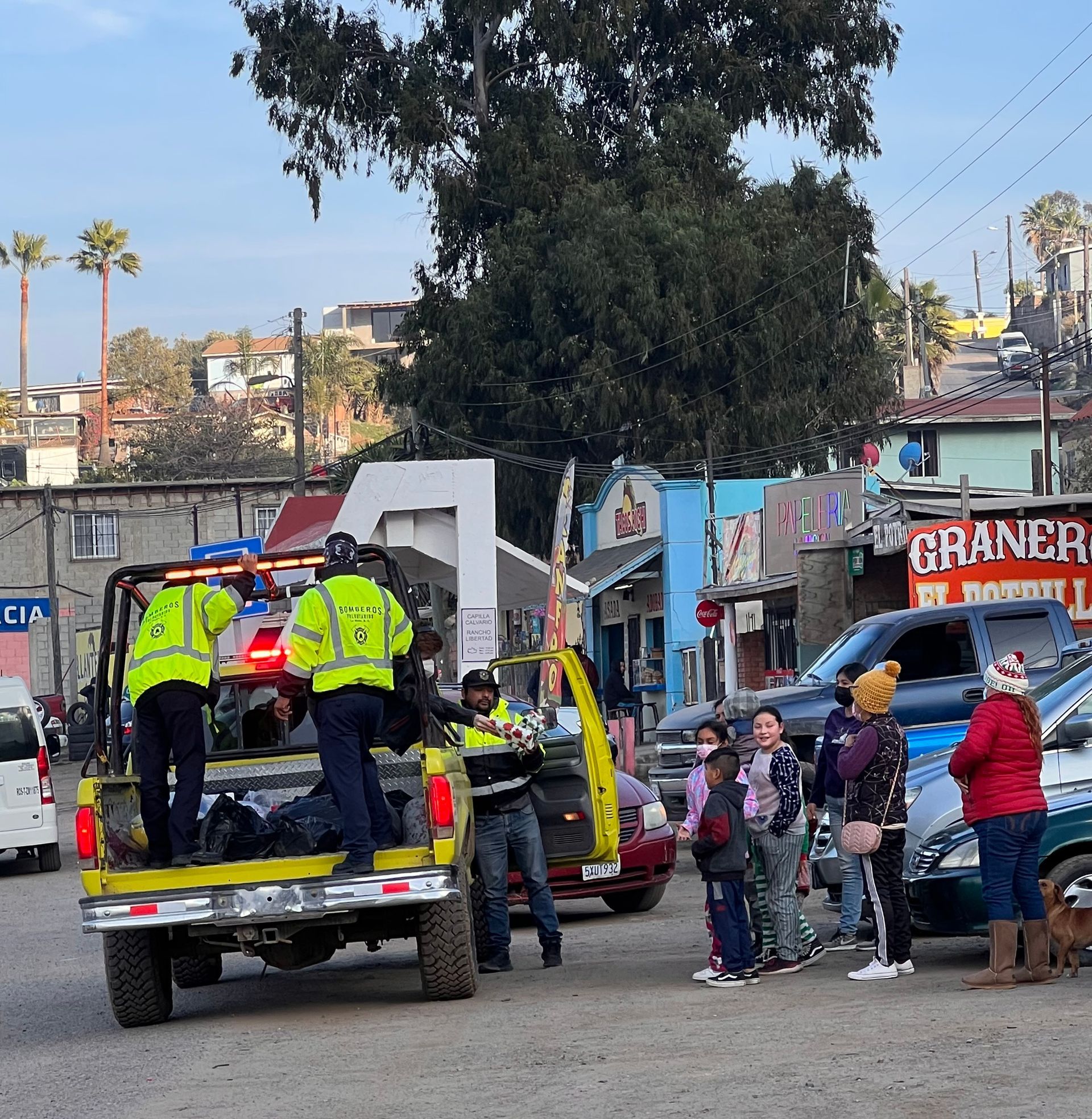 La Mision Bomberos handing out gifts to children in La Mision