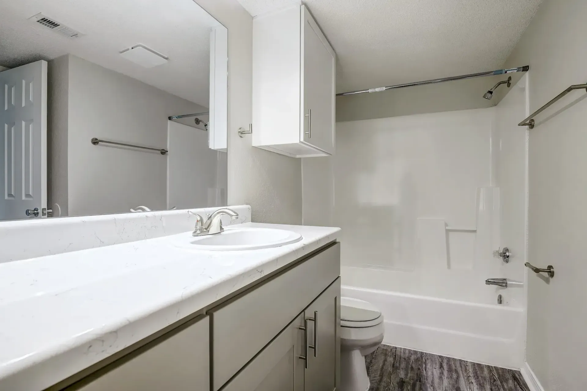 An empty bedroom with a washer and dryer in it.
