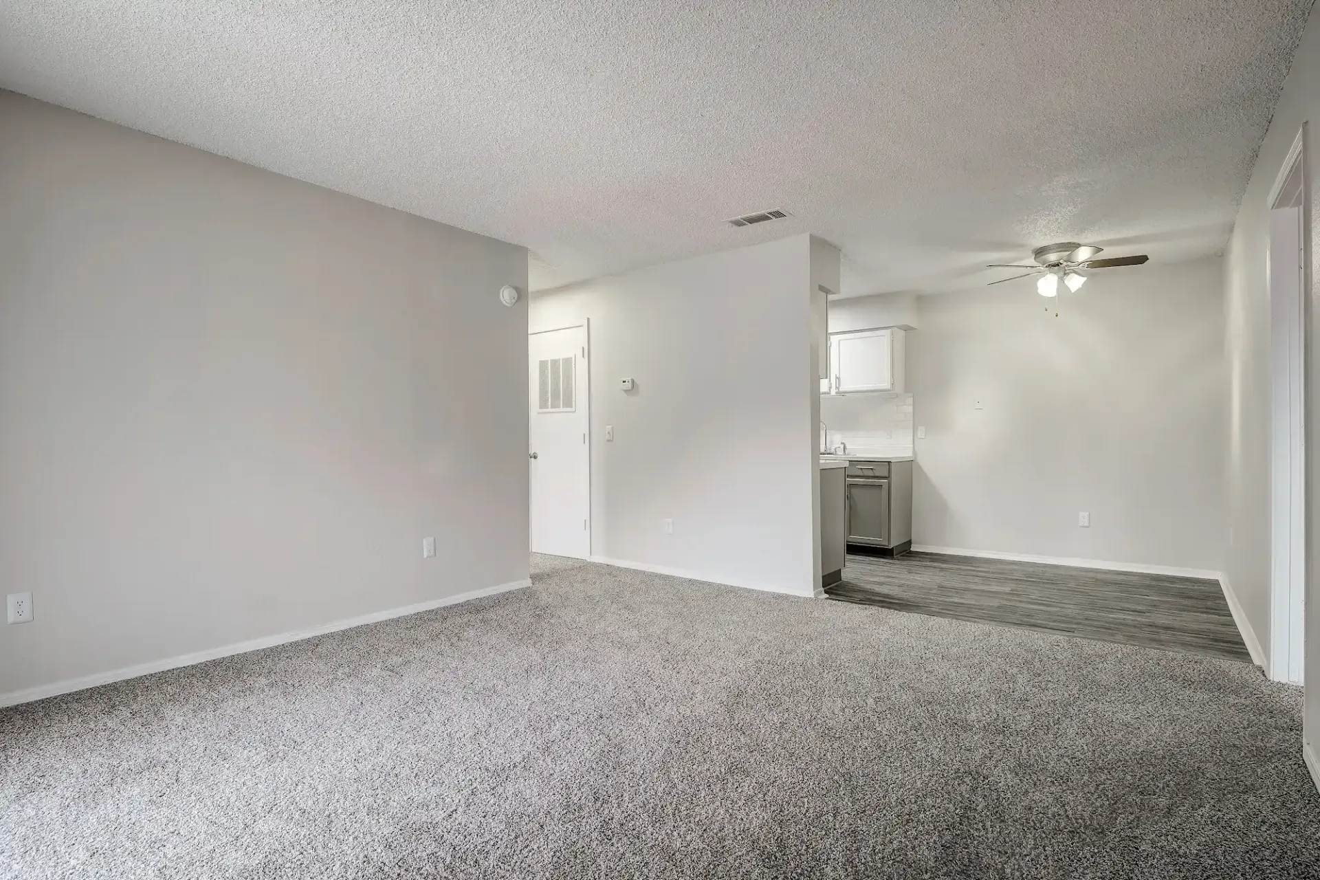 An empty bedroom with a washer and dryer in it.