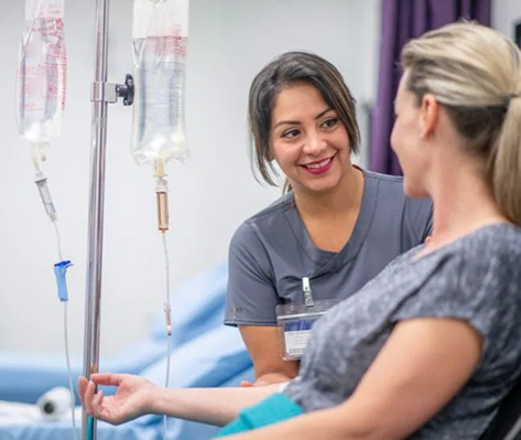 Nurse caring for a smiling patient during an IV session