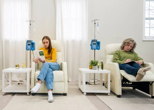 Two patients relaxing during IV therapy sessions at a clinic