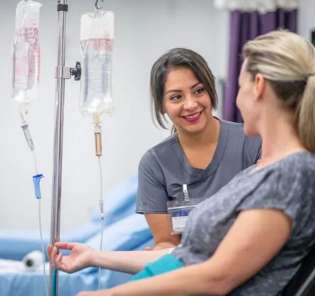 Nurse caring for a smiling patient during an IV session